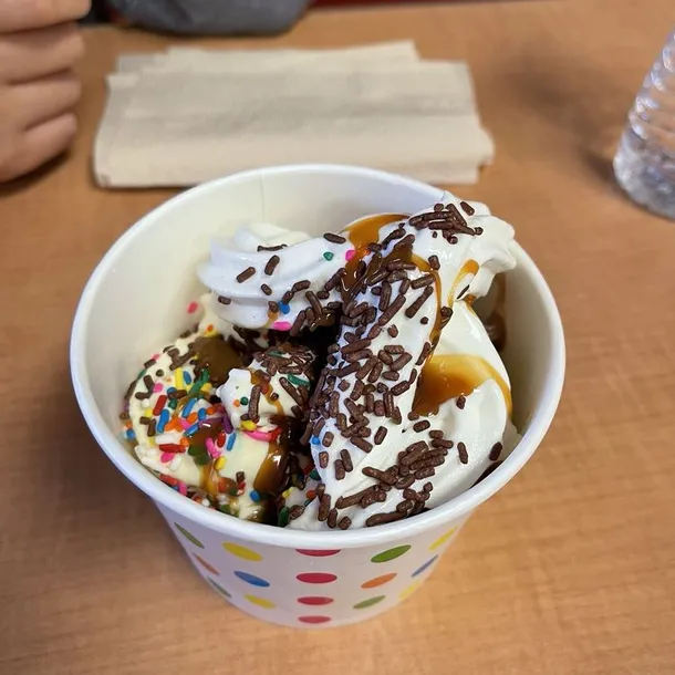 Swirled frozen yogurt topped with strawberries, mango, blueberries and popping boba